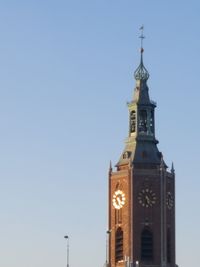 Low angle view of clock tower against clear blue sky