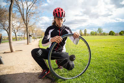 Man sitting on bicycle in field