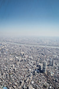 High angle view of city buildings against clear sky