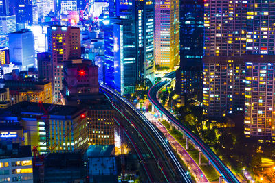 High angle view of illuminated city street and buildings at night