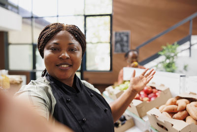 Portrait of young woman holding food