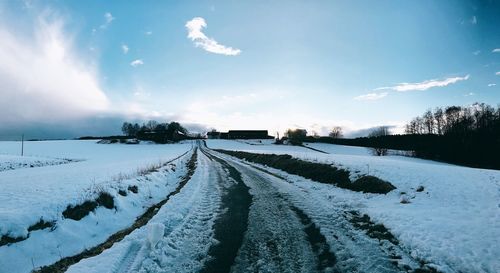 Snow covered landscape against sky