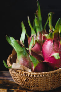 Dragon fruits in basket on table