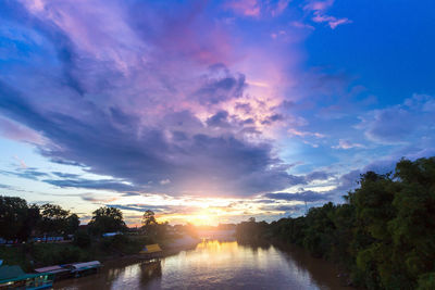 Scenic view of river against sky at sunset