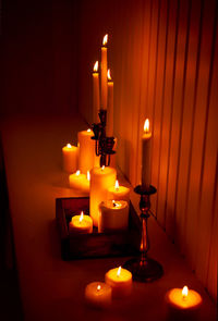 Close-up of illuminated lamp on table in darkroom