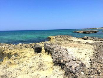 Scenic view of sea against clear blue sky