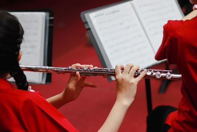 Rear view of woman playing musical instrument