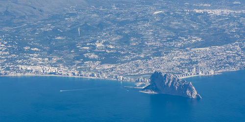 Aerial view of sea by snowcapped mountain