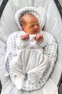 High angle view of baby girl sleeping on bed