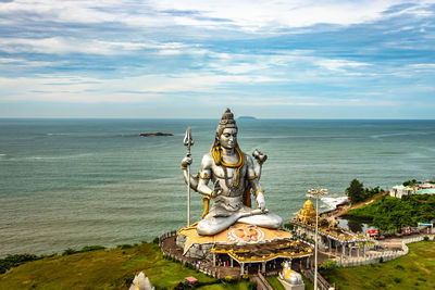 Shiva statue isolated at murdeshwar temple aerial shots with arabian sea in the backdrop