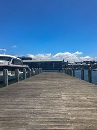 Pier over sea against blue sky