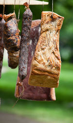 Close-up of smoked bacon hanging outdoors