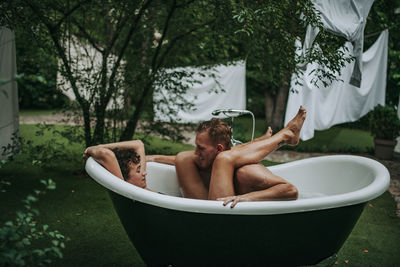 Couple in bathtub outdoors