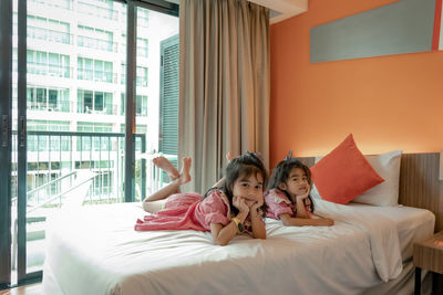 Two daughters lying on bed