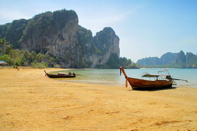 Scenic view of sea and mountains against sky