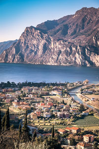 High angle view of townscape by sea against sky