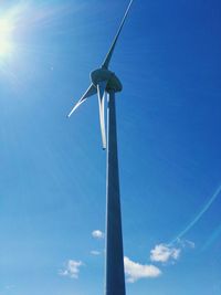 Low angle view of wind turbine against blue sky