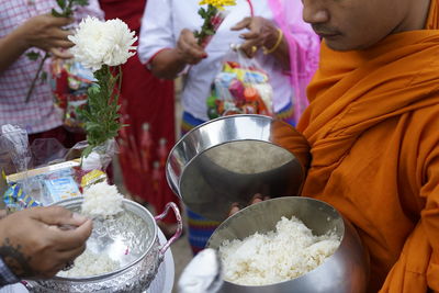 Midsection of people holding food