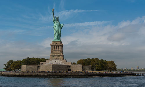 Statue of liberty against cloudy sky