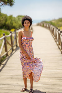 Young woman standing on footbridge