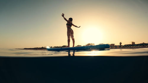 Rear view of man jumping in water