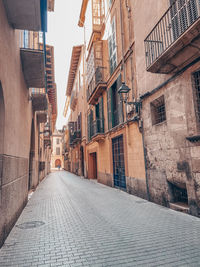 Empty alley amidst buildings in city