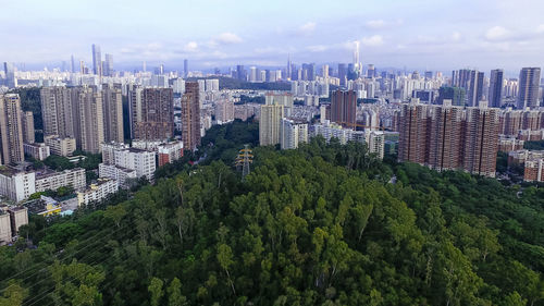High angle view of modern buildings in city against sky