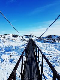 Snow covered mountain against blue sky