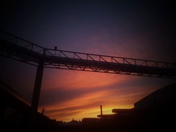 Low angle view of silhouette bridge against sky during sunset