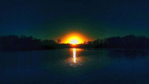 Scenic view of lake at sunset