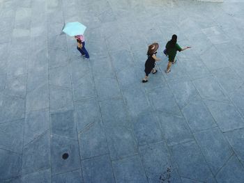 High angle view of people walking on rainy day