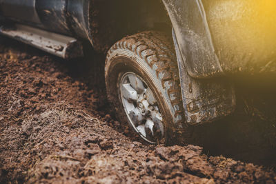 Close-up of tire on dirt road