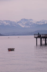 Scenic view of sea and mountains against sky