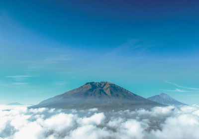 Scenic view of snowcapped mountain against blue sky