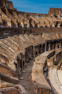 Tourists visiting the interior of the famous colosseum in rome