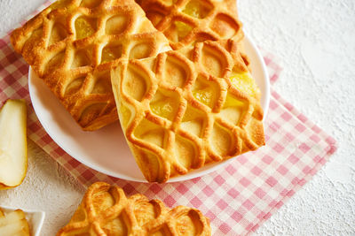 Puff pastry mini pies with with pear and lime jam filling on a white plate