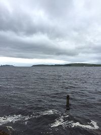 Scenic view of sea against cloudy sky