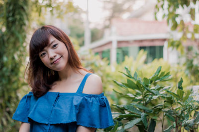 Portrait of young woman standing outdoors