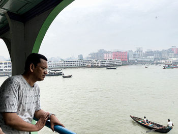 Man on boat against river