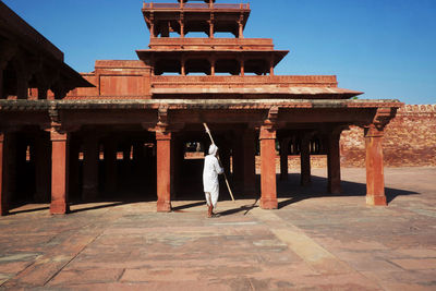 Full length of woman in historic building against sky