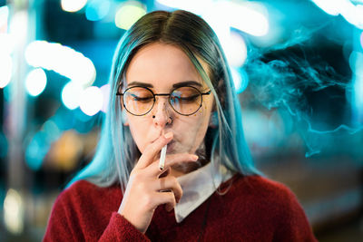 Portrait of young woman smoking