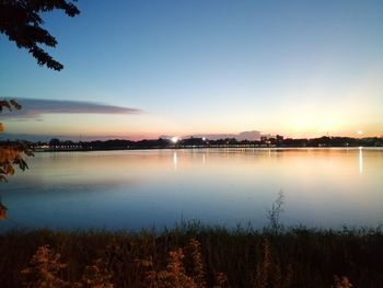 Scenic view of lake against sky at sunset