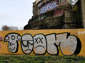 Low angle view of graffiti on wall against building