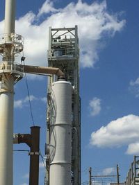 Low angle view of smoke stack against sky