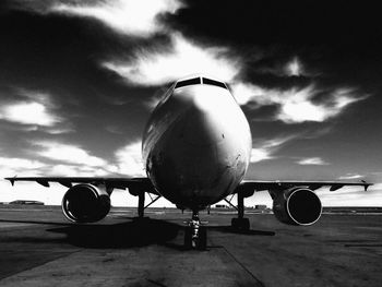 Airplane on runway against sky