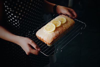 Close-up of person holding cake