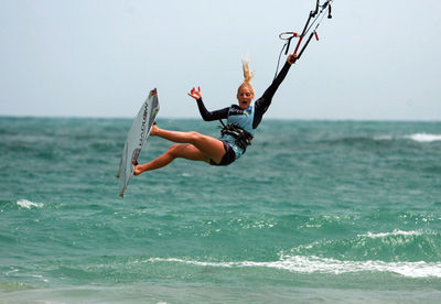 Woman jumping in sea