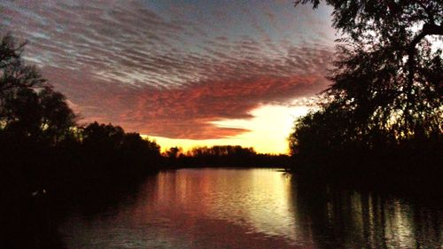 Scenic view of lake against sky during sunset