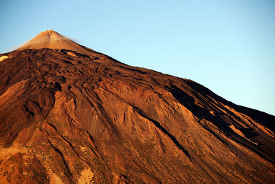 Rocky mountain at el teide national park against clear blue sky