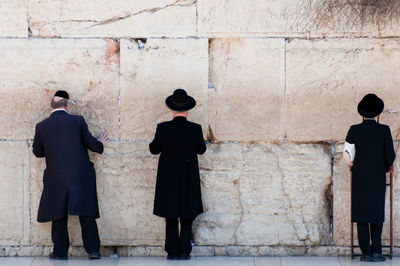 Orthodox jewish men praying at the wailing wall